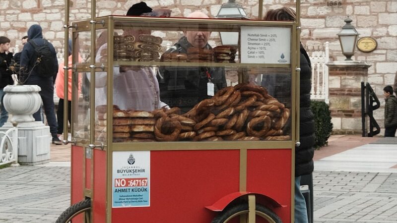 a red cart filled with lots of donuts